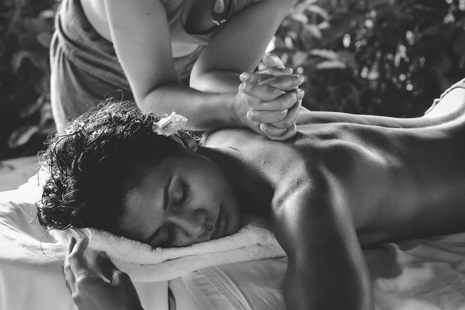 grayscale photo of woman getting a massage. Brisbane Livewell Clinic.