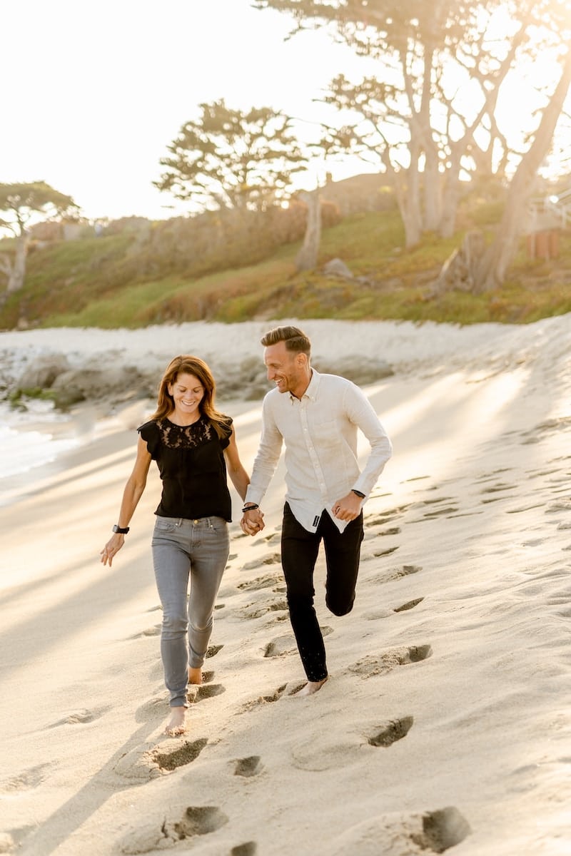 Overcoming Health Issues. Man in white dress shirt and woman in black dress walking on beach during daytime. Brisbane Livewell Clinic