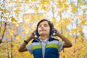 Photo of a Boy Listening in Headphones. Naturopathic Care for Children. Brisbane Livewell Clinic