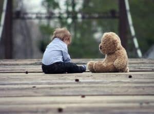 Sad boy sitting with Bear. Naturopathic Care for Children. Brisbane Livewell Clinic