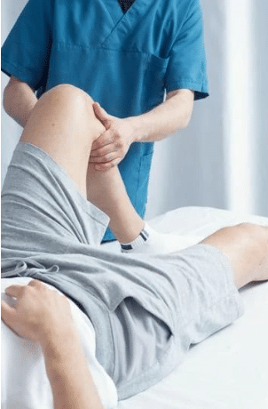Physio treating a patient's knee. Physiotherapist Near Me