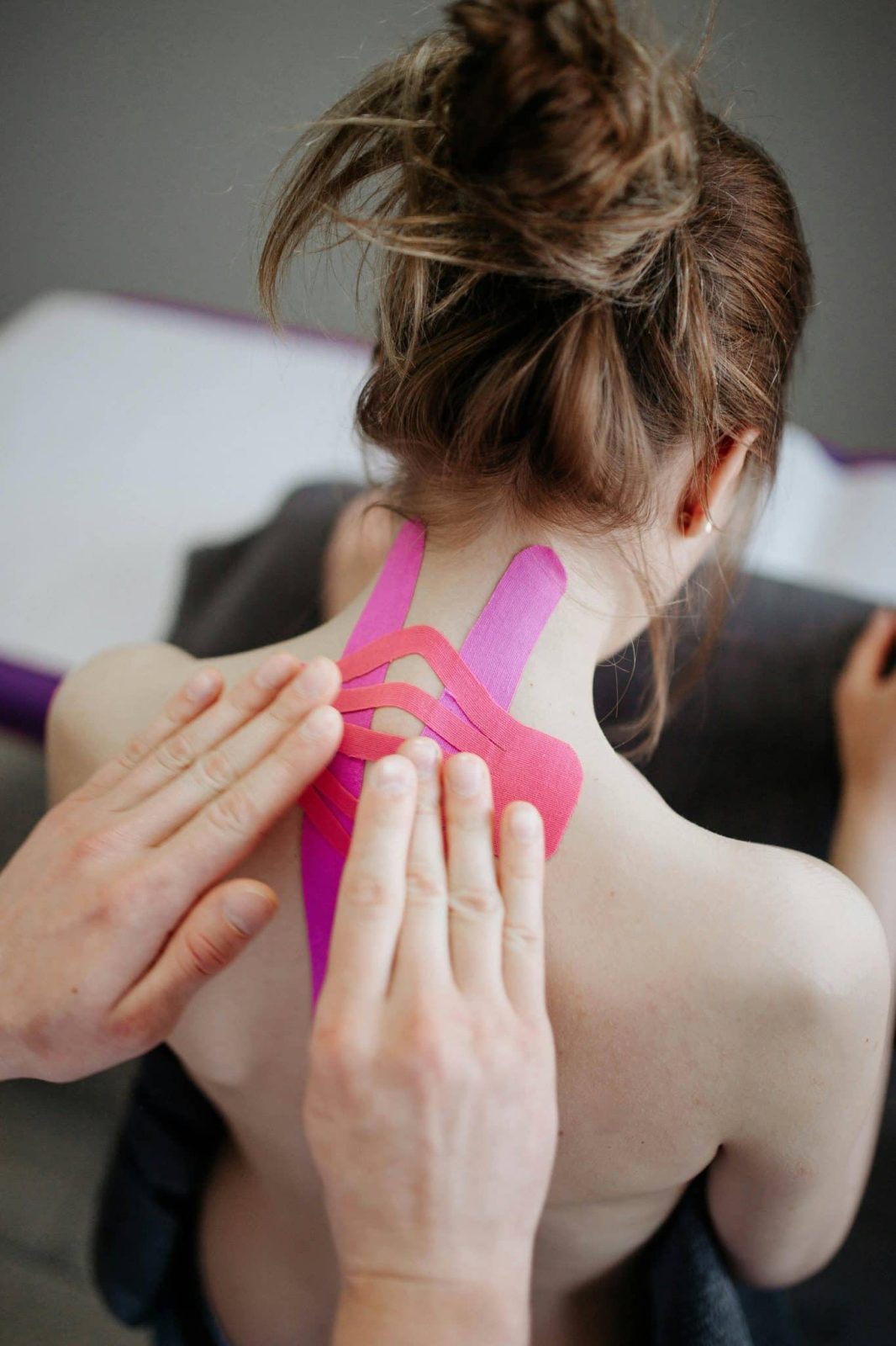 woman with kinesio tape on her neck and back